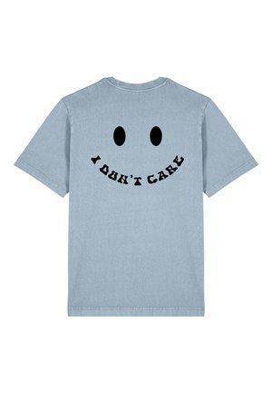 Light blue cotton t-shirt featuring a black smiley face with the text "I DON'T CARE" in bold, curved letters under the face.