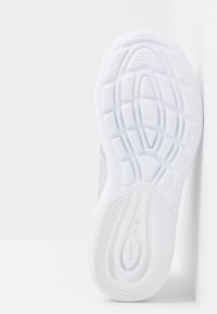 Vit sneakersula med texturerat mönster, med spår för grepp och en synlig logotyp. Slätt och hållbart material.