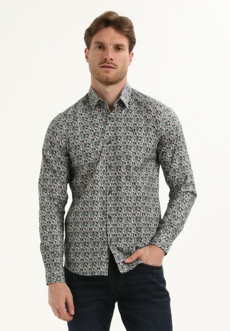 Camicetta a maniche lunghe con un motivo geometrico in colori tenui su uno sfondo chiaro. Presenta un collo classico e un design aderente.