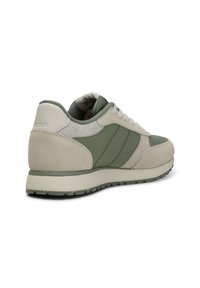 Sneaker featuring a mix of green and beige suede, mesh, and leather. Rounded shape with textured accents and white laces. Rubber sole.