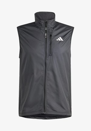 Black sleeveless vest made of lightweight fabric. Features front zip, high collar, and a small logo on the upper left side. Smooth texture.