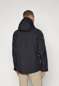 Black waterproof jacket with a hood, featuring a smooth texture and adjustable cuffs. Minimalist design, suitable for outdoor use.