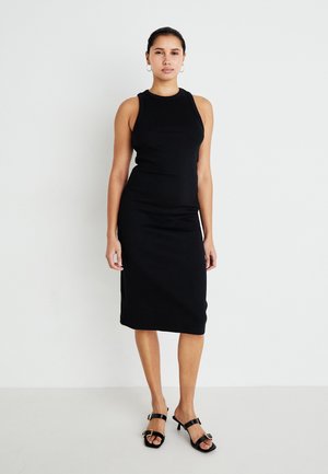 Black ribbed midi dress with a sleeveless design and round neckline. Worn with black open-toe heeled sandals featuring gold accents.