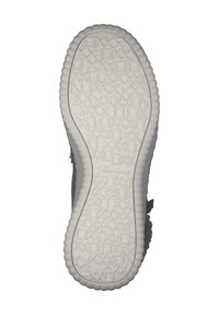 Semelle de chaussure en caoutchouc blanc avec un motif alphabétique texturé et des bords arrondis, marquée "Skechers" près du talon.