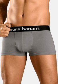 Boxers grises para hombre con una cinturilla negra donde aparece impresa en blanco la marca "bruno banani". La tela parece suave y elástica.