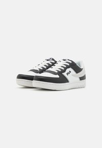 Black and white athletic shoes with a smooth leather upper, white laces, and a padded collar. Features a stitched design and textured sole.