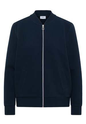 Marineblauwe geribbelde jas met ritssluiting, opstaande kraag, lange mouwen, twee voorzakken en een zilverkleurige ritssluiting, met het label "Cecil".