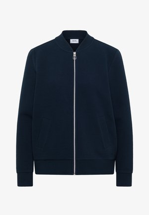 Veste zippée côtelée bleu marine avec col montant, manches longues, deux poches avant et fermeture éclair argentée, étiquetée "Cecil".