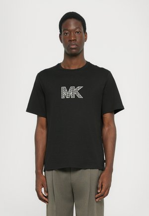 T-shirt noir en coton avec un logo géométrique blanc "MK" sur la poitrine. Manches courtes et design col rond.