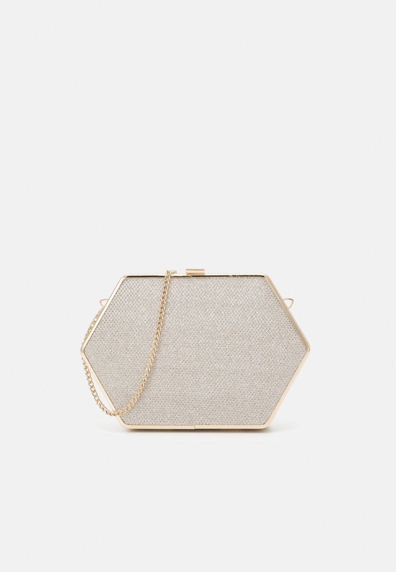 Pochette hexagonale en tissu beige clair, avec des ferrures métalliques dorées et une bandoulière chaîne. Surface texturée avec une fermeture à fermoir sécurisé.