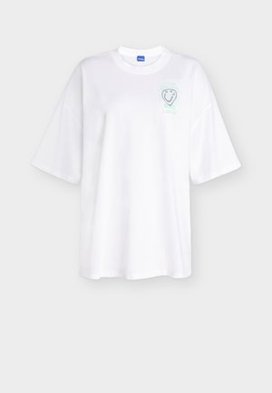 White oversized short-sleeve T-shirt with a round neck and small light green graphic and text on the left chest reading "Future Love."