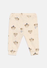 Μπεζ παντελόνια μωρού με ελαστική μέση και μανσέτες, διακοσμημένα με διάφορες φιγούρες αρκούδας που φορούν καπέλα, κασκόλ και γυαλιά.