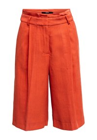 Oranžové plisované culotty vyrobené z lnu, s vysokým pasem, bočními kapsami a volným střihem. Hladká textura s ostrými sklady.