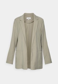 Blazer bege com um corte ajustado, mangas longas, frente aberta, dois bolsos laterais e uma textura suave. Design simples sem padrões visíveis.