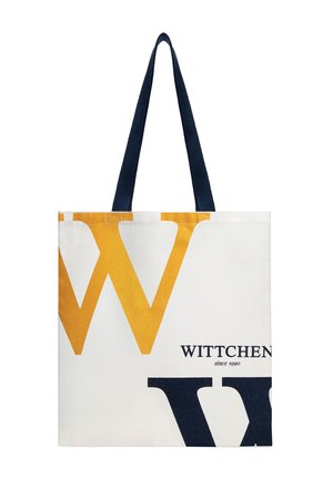 Bílá taška přes rameno s velkým žluto-černým písmenem "W" a černými držadly, na přední straně s nápisem "WITTCHEN since 1990".