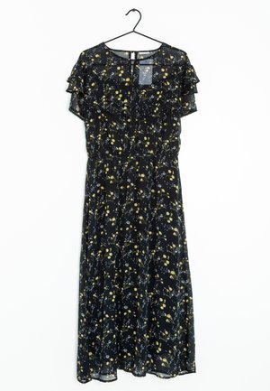 Robe midi noire avec imprimé floral jaune et blanc, manches courtes à volants, et fermeture au dos avec bouton et ouverture en forme de goutte, suspendue sur un cintre noir.