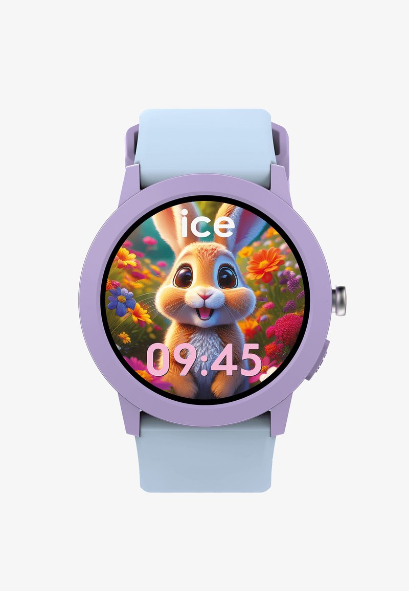 Chytré hodinky s fialovým rámečkem a modrým páskem zobrazující kresleného zajíčka s velkýma očima mezi barevnými květinami, čas ukazuje 09:45.