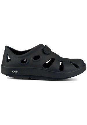 Black clogs with ventilation holes, made from lightweight material. Features a Velcro strap and contoured sole for comfort.