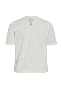 Blouse blanche à manches courtes avec motif en dentelle, petite ouverture dos en forme de trou de serrure et épaules légèrement bouffantes.