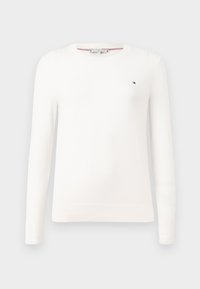 Hvit strikket genser med rund hals og lange ermer. Har en liten logo på brystet samt ribbestrikkede mansjetter og hem.