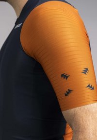 Form-fitting short-sleeve shirt featuring a navy body and textured orange sleeves with black triangular patterns and ribbed texture.