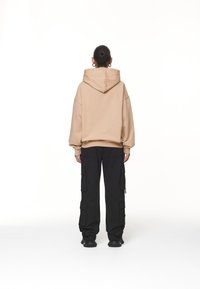 Pegador Jersey con capucha - sand