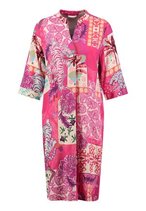 Colorful tunic featuring a mix of floral and animal patterns, predominantly in pinks with accents of cream and green. V-neck and 3/4 sleeves.