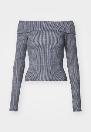 Off-the-shoulder long-sleeve top in navy with white vertical stripes. Fitted design, ribbed texture, and cropped length.