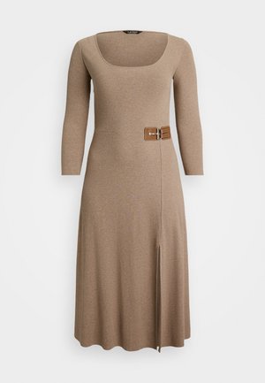 Beige midi-jurk met lange mouwen, vierkante halslijn, zijgesp detail en een split aan de voorkant op een effen witte achtergrond.