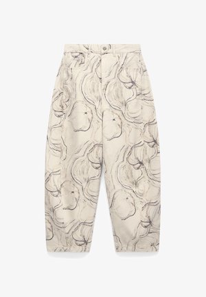 Beige pants with loose fit and high waist, featuring black abstract floral sketch pattern, front pockets, button, and zipper closure.