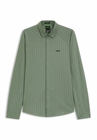 Camicia a maniche lunghe di colore verde chiaro con una texture a motivo. Presenta un colletto, una chiusura con bottoni sul davanti e un piccolo logo nero sul petto.