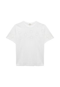 Hvid bomulds t-shirt med korte ærmer, der har et blonde-lignende broderet design på forsiden, og en rund halsudskæring.