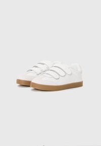 White sneakers with a smooth leather upper, velcro straps, perforated detailing, and a gum rubber outsole.