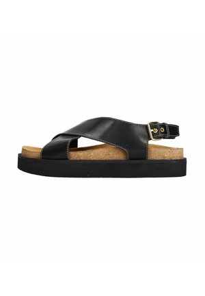 Zwarte leren sandaal met een kruisriemdesign, kurken voetbed en een dikke zwarte rubberen zool. Voorzien van een gouden gespdetail.