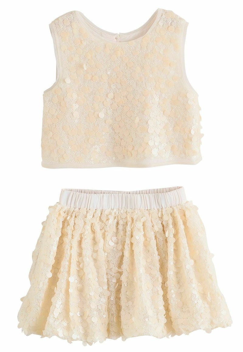 Tweedelig outfit met een mouwloze, crèmekleurige top met pailletten en een bijpassende flare rok met een elastische tailleband.