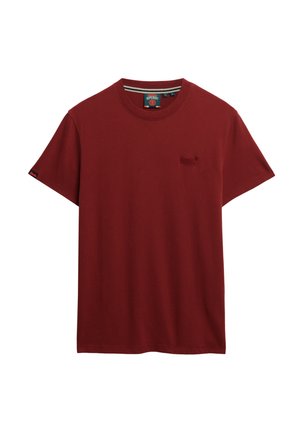 Camiseta de algodón roja con cuello redondo, mangas cortas y un pequeño logo bordado en el pecho. Textura suave y diseño informal.