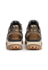 Brown textured sneakers with metallic accents, black detailing, and a chunky sole featuring deep treads for traction and support.