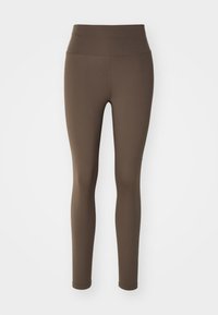 Bruna högmidjade leggings gjorda av stretchigt tyg. De har en mjuk yta, åtsittande form och inga synliga mönster eller detaljer.