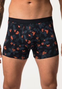 Black boxer shorts with a floral pattern featuring orange and dark green accents. Made from soft fabric, with a comfortable waistband.