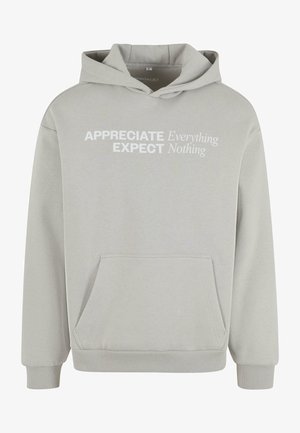 Light grey hoodie made of cotton blend with front kangaroo pocket. Features white text "APPRECIATE EXPECT Everything Nothing" on chest.
