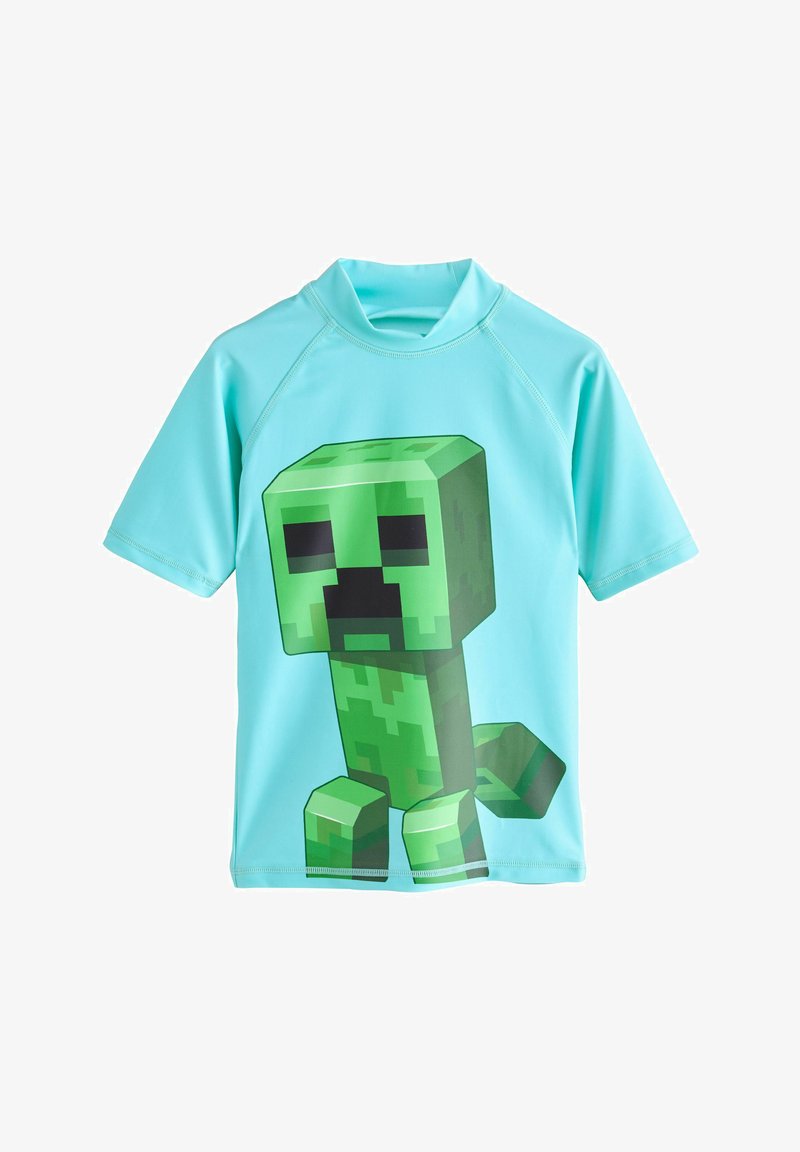 Chemise bleu clair à manches courtes avec un grand personnage Minecraft Creeper vert pixellisé sur le devant.