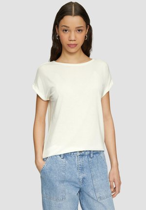 White short-sleeve t-shirt with rolled cuffs, lightweight fabric, and a relaxed fit, paired with light blue high-waisted jeans.