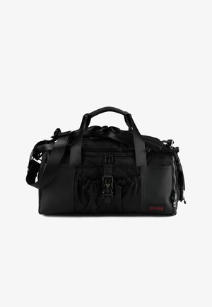Sac de voyage en nylon noir avec sangles réglables, finitions texturées, poche avant et détail élastique. Présente un logo de marque en rouge.