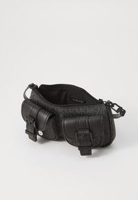 Black fabric bag with a textured finish, featuring two external zippered pouches, adjustable strap, and logo detail inside.
