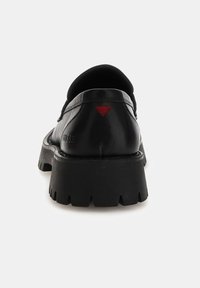 Black leather shoe featuring a rounded toe, thick black sole, and red triangular accent on the heel. Smooth texture with minimal detailing.