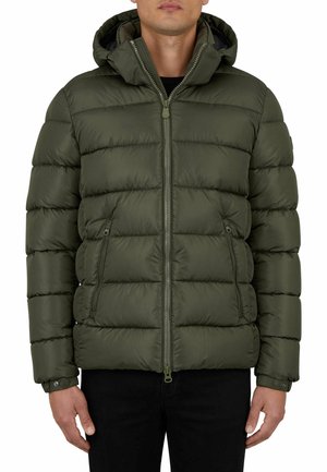 Man wearing a zipped olive green puffer jacket with a hood, two front zip pockets, and buttoned cuffs, paired with black pants.