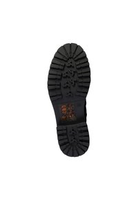 Black rubber boot sole featuring a rugged tread pattern with deep grooves for traction. Includes a small label with safety symbols in orange.