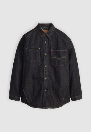 Dark denim shirt featuring a button front, two chest pockets, and contrasting stitching. Relaxed fit with a classic collar and curved hem.
