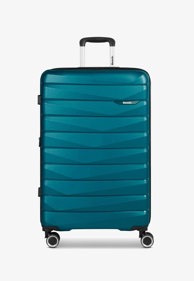 Türkisfarbene Hartschalenreisetasche mit strukturiertem Zickzackmuster, ausziehbarem Griff und vier Doppelrollen für einfache Mobilität.