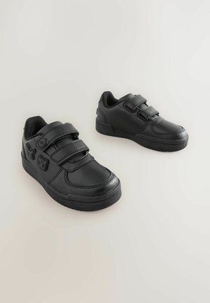 Black sneakers made of leather with a smooth finish, featuring two adjustable Velcro straps and a textured rubber sole.